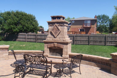 Patio - large traditional backyard brick patio idea in Chicago with a fire pit and no cover