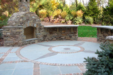 Imagen de patio clásico de tamaño medio sin cubierta en patio trasero con brasero y losas de hormigón