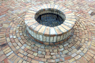 Inspiration for a brick patio remodel in Tampa with a fire pit