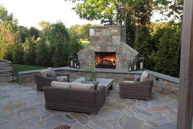 Farmhouse backyard stone patio photo in Baltimore with a fire pit and a pergola