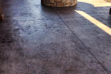 Inspiration for a mid-sized rustic backyard stamped concrete patio remodel in Oklahoma City with a fire pit and a pergola
