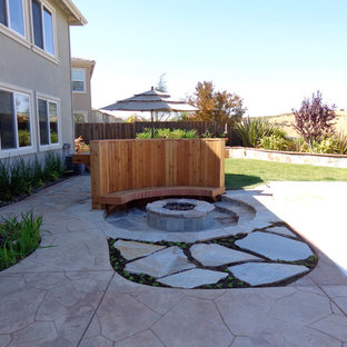 Example of a mid-sized classic backyard stone patio design in San Francisco with a fire pit and no cover