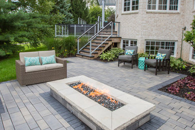 Large trendy backyard concrete paver patio photo in Indianapolis with a fire pit