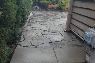 Mid-sized minimalist backyard concrete paver patio photo in Vancouver with no cover