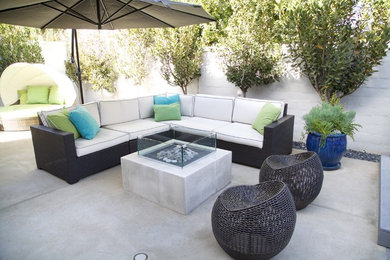 Inspiration for a large contemporary backyard concrete patio remodel in Orange County with a fire pit and a gazebo