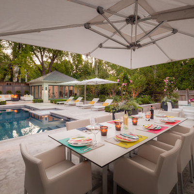 Mid-sized elegant backyard stone patio photo in Toronto