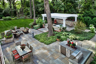 Inspiration for a large transitional shade backyard stone and wood fence landscaping in Chicago with a pergola for summer.