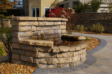 Patio fountain - backyard brick patio fountain idea in Milwaukee