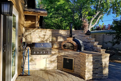 Inspiration for a mid-sized contemporary backyard patio kitchen remodel in Tampa with no cover
