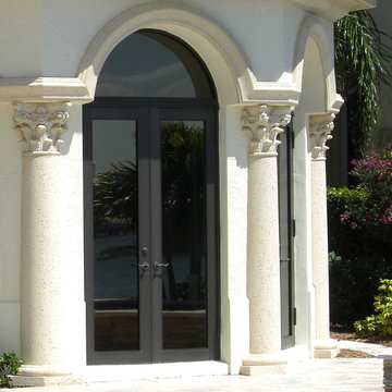 French doors, columns, and arched windows
