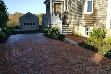 Inspiration for a large timeless side yard brick patio remodel in Boston with no cover