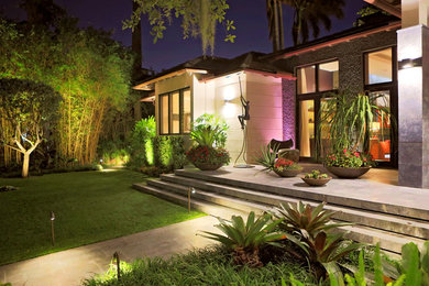Example of a trendy front yard patio design in Miami with no cover