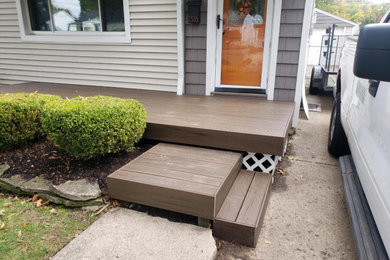 Example of a front yard patio design in Detroit with decking and no cover