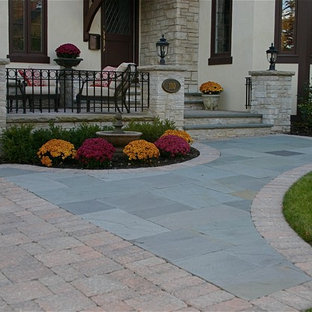 Inspiration for a small timeless front yard stone patio remodel in Chicago
