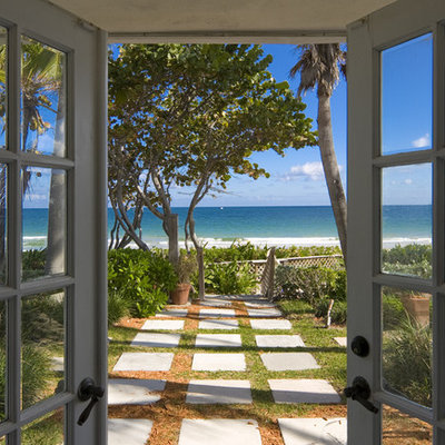 Island style backyard patio photo in Miami