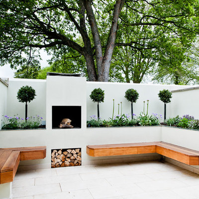 Example of a small trendy backyard stone patio design in Wiltshire with a fire pit