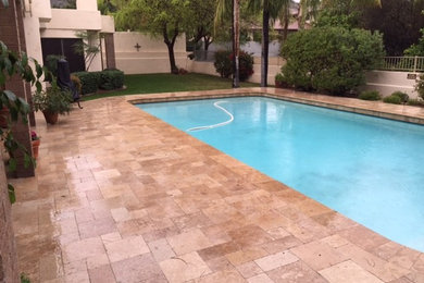 Example of a mid-sized tuscan backyard tile and custom-shaped pool design in Phoenix