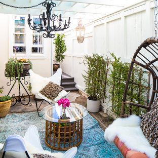 Ispirazione per un piccolo patio o portico bohémian in cortile con un giardino in vaso, una pergola e pavimentazioni in cemento