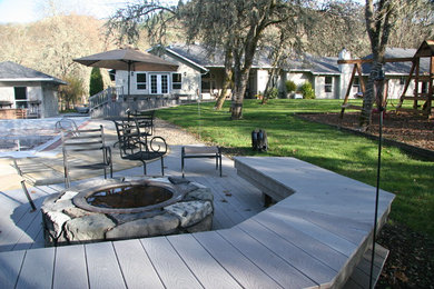 Diseño de patio clásico de tamaño medio sin cubierta en patio trasero con brasero y entablado
