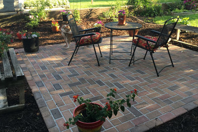 Photo of a medium sized traditional back patio in Minneapolis with brick paving and no cover.