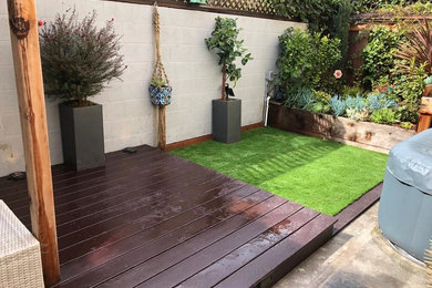 Patio container garden - small transitional backyard patio container garden idea in San Francisco with decking and a pergola