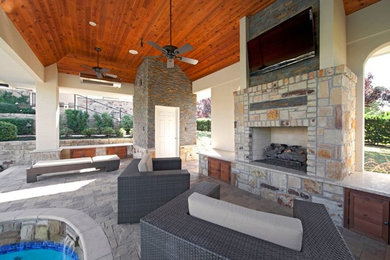 Trendy backyard patio photo in Dallas with a fire pit and a roof extension