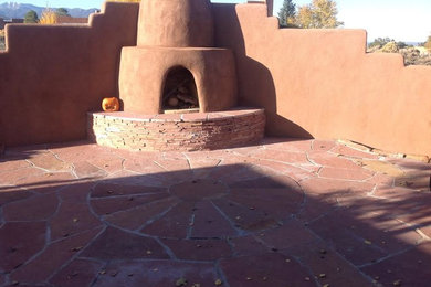 Mid-sized southwest backyard stone patio kitchen photo in Albuquerque with no cover