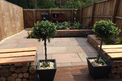Photo of a small modern back patio in Manchester with a water feature and decking.