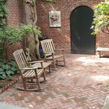 Garden level view with herringbone patio, looking toward alley door