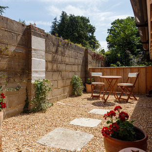 Design ideas for a small traditional back patio in Dorset with gravel and no cover.