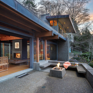 Inspiration for a large asian front yard concrete patio remodel in Other with a fire pit and a roof extension