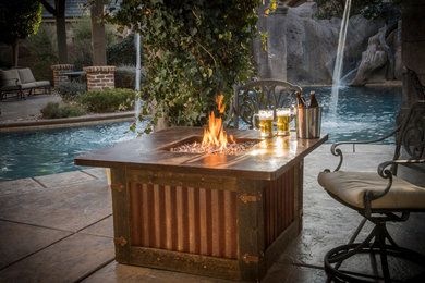Medium sized rustic back patio in Los Angeles with a fire feature.