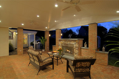 Inspiration for a large timeless backyard patio remodel in Philadelphia with a fire pit and a roof extension