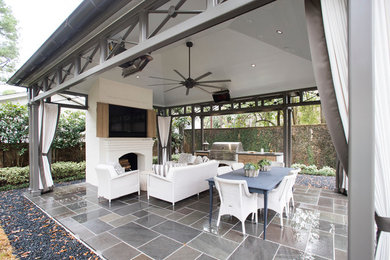 Inspiration for a large transitional backyard concrete paver patio remodel in Houston with a fire pit and a gazebo
