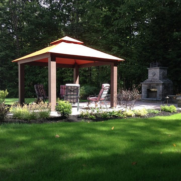 Gazebo and outdoor fireplace with sitting wall and small fountian
