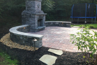 Inspiration for a medium sized classic back patio in Boston with a fireplace, brick paving and a gazebo.