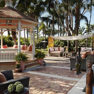 Inspiration for a tropical patio remodel in Miami with a gazebo