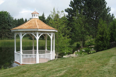 Example of a mid-sized classic backyard patio design in Toronto with decking and a gazebo