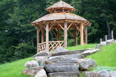 Design ideas for a patio in New York with natural stone paving and a gazebo.