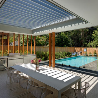 Inspiration for a mid-sized contemporary backyard patio in Sydney with an outdoor kitchen, a pergola and concrete slab.