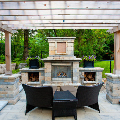 Large elegant backyard concrete paver patio photo in Toronto with a pergola
