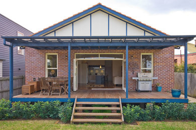 This is an example of a small traditional back patio in Sydney with decking and an awning.