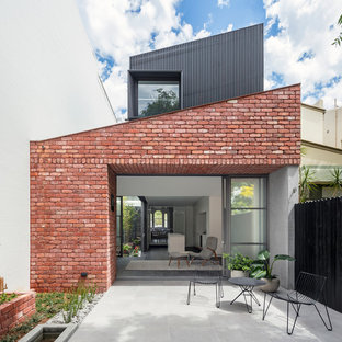 Photo of a contemporary backyard patio in Sydney with stamped concrete and no cover.
