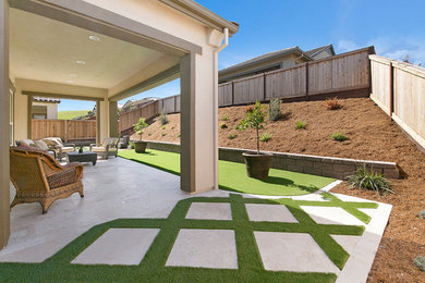 Patio - mid-sized contemporary backyard concrete paver patio idea in San Francisco with a roof extension