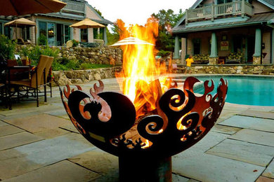 Example of a minimalist patio design in Grand Rapids with a fire pit