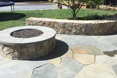Patio - mid-sized traditional backyard stone patio idea in San Francisco with a fire pit and no cover