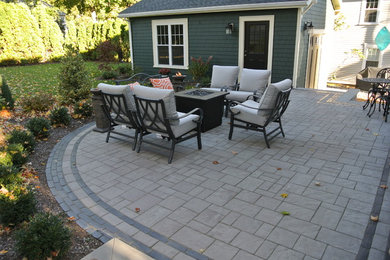 Photo of a medium sized contemporary back patio in Providence with concrete paving.
