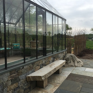 greenhouse and stone patio