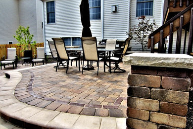 Example of a mid-sized trendy backyard concrete paver patio fountain design in Chicago