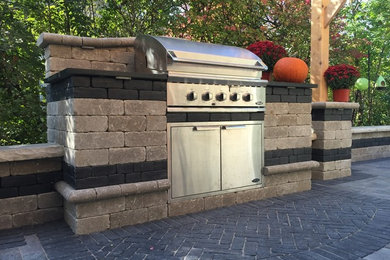 Patio kitchen - mid-sized traditional backyard stone patio kitchen idea in Chicago with no cover